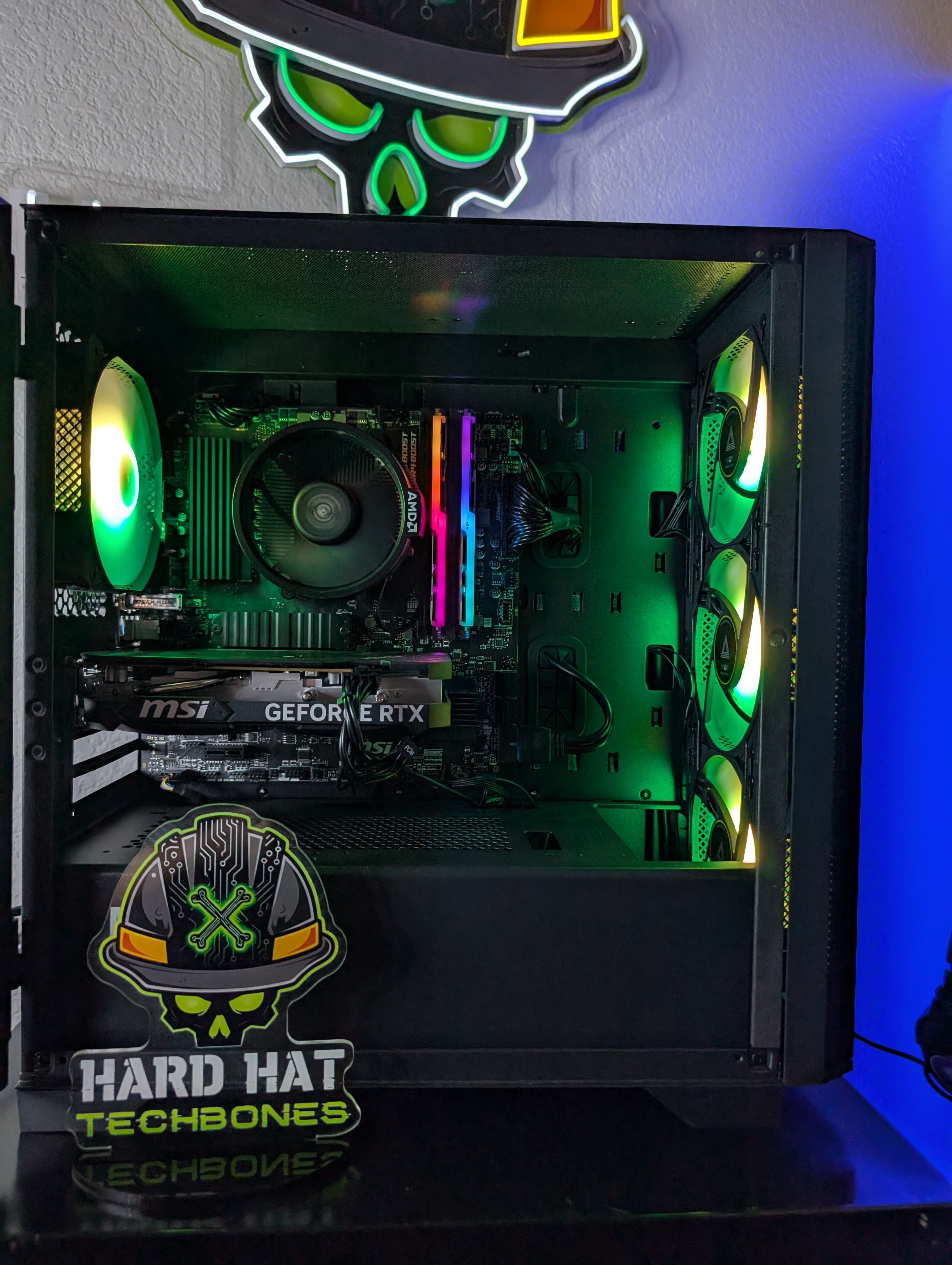 Gaming PC build interior with green and yellow lighting